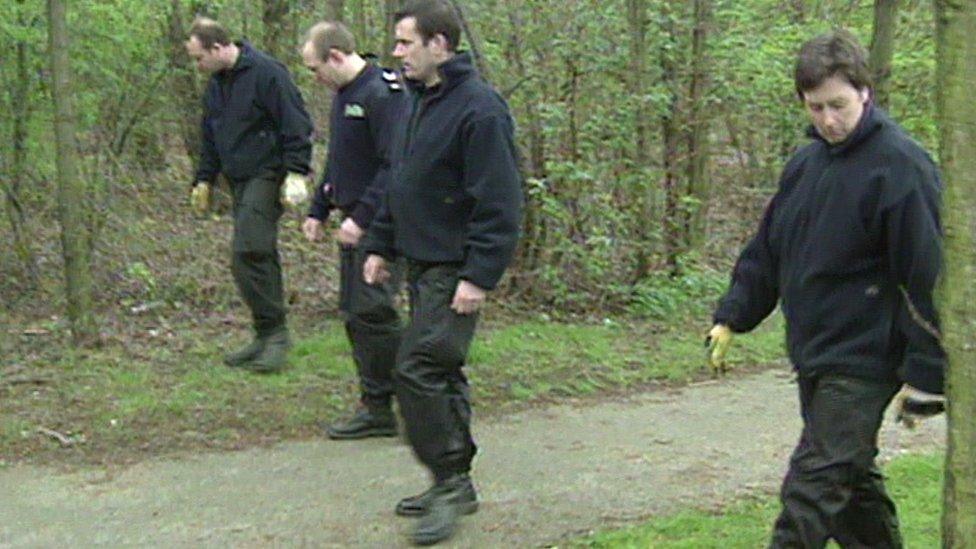 Police search the woods after the discovery of the baby in 1998