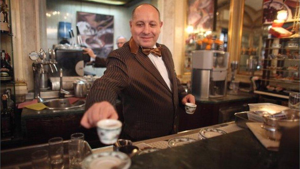 A barista serves coffee in Naples, Italy