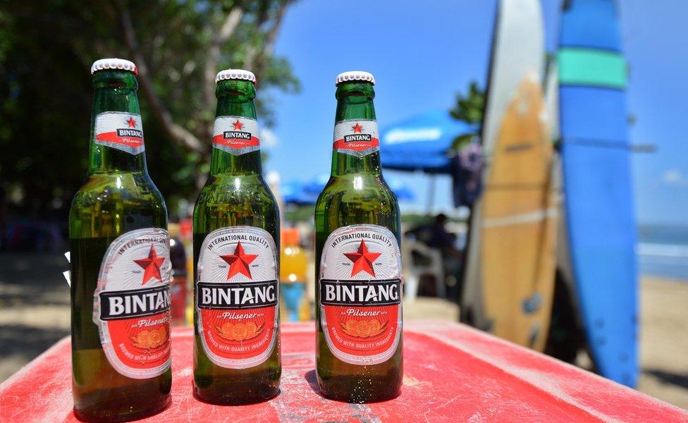 Bottles of beer on a cooler on a beach in Bali