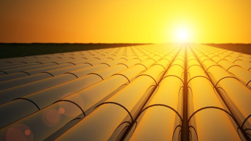 Oil pipelines in sunset