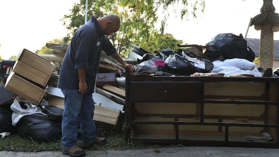 Ernesto Ramirez pauses as he cleans out his house that had been inundated with water on September 2, 2017 in Houston, Texas.