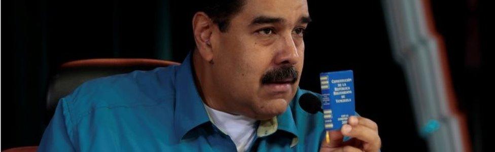 Venezuela's President Nicolas Maduro holds a copy of the Venezuelan constitution as he speaks during his weekly broadcast "Los Domingos con Maduro" (The Sundays with Maduro) in Caracas, Venezuela April 30, 2017.