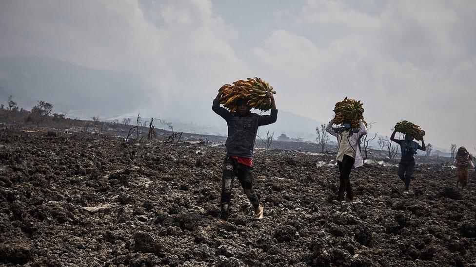 Congolese communities walking across lava flows in Kibati, North of the city of Goma, in the aftermath of a volcanic eruption in North Kivu, Democratic Republic of Congo, 25 May 2021