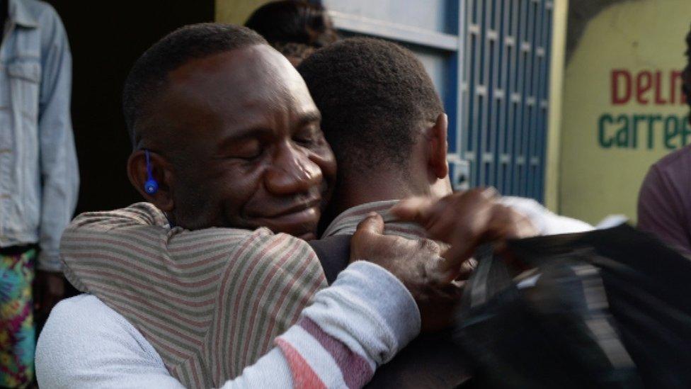 Israel Charles embraces his son David