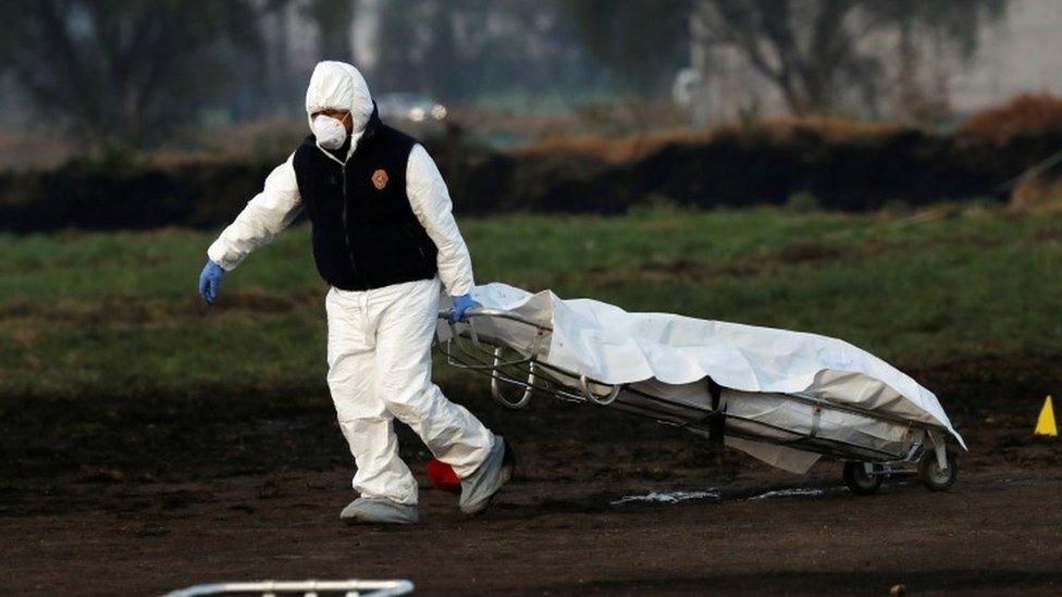 Emergency workers retrieve remains