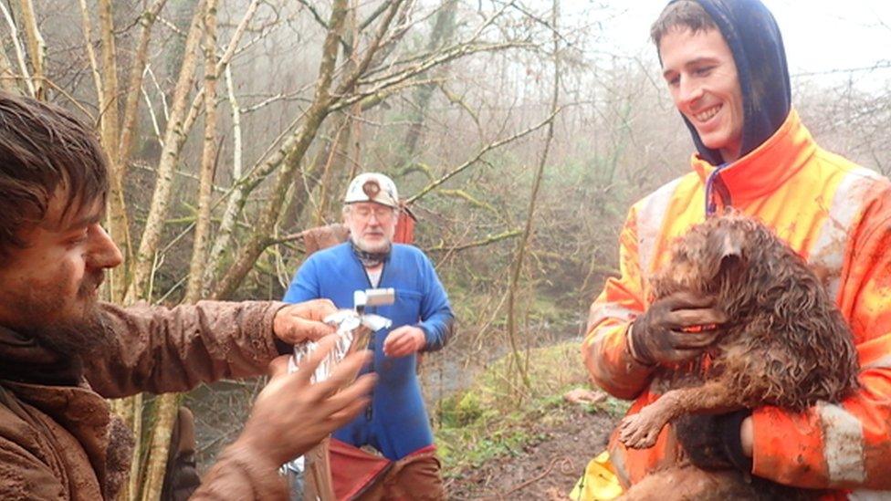 The team take photos after the dog is rescued