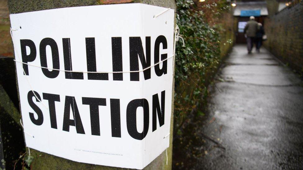 A couple enter a temporary polling station