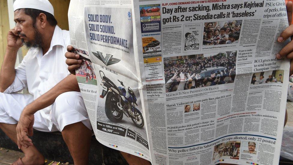 A man reading a newspaper in India