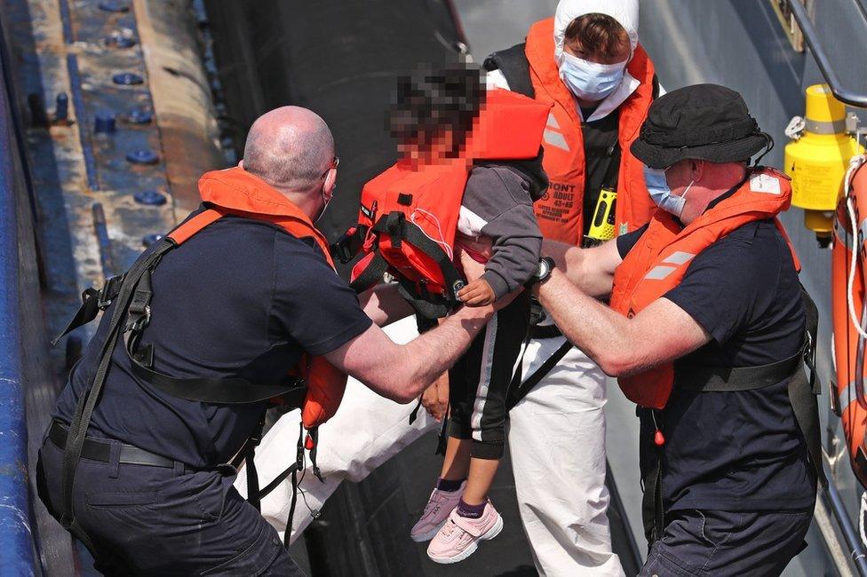 A group of migrants, including children, are brought to Dover on Thursday 3 June