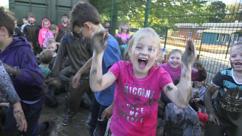 Children following a mud run