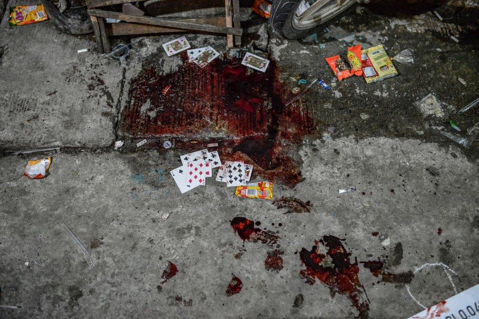 Playing cards are seen soaked in blood belonging to a suspected drug pusher who was killed by unknown assailants in Navotas, Metro Manila, Philippines, April 1, 2018.