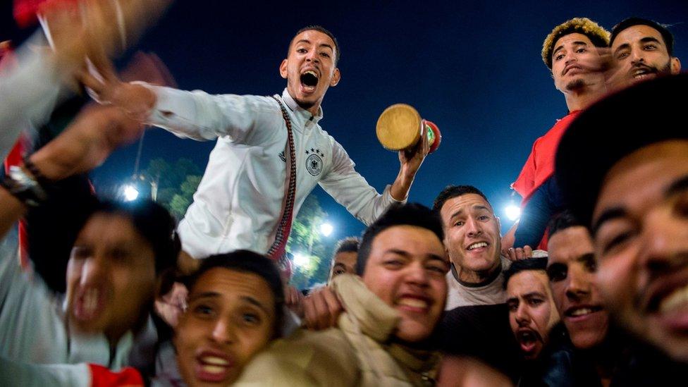 Moroccans celebrate November 11, 2017 in Marrakech following Morocco"' victory over Ivory Coast in their FIFA 2018 World Cup Africa Qualifier to participate the FIFA 2018 World Cup.