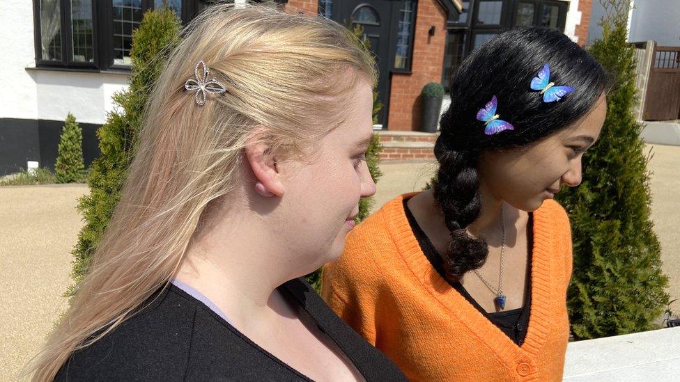 The Wanted fans Bethan and Tamara show their butterfly hairclips in memory of Tom Parker