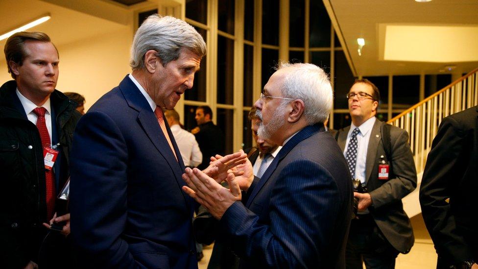 In this Jan. 16, 2016 file-pool photo, Secretary of State John Kerry talks with Iranian Foreign Minister Mohammad Javad Zarif in Vienna, after the International Atomic Energy Agency (IAEA)