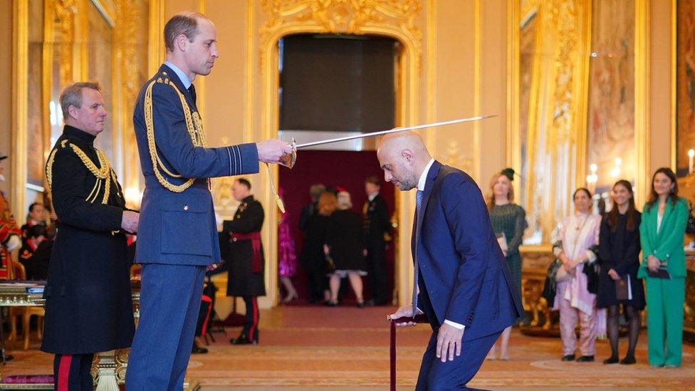 Sir Sajid Javid bends down before Prince William to receive his knighthood