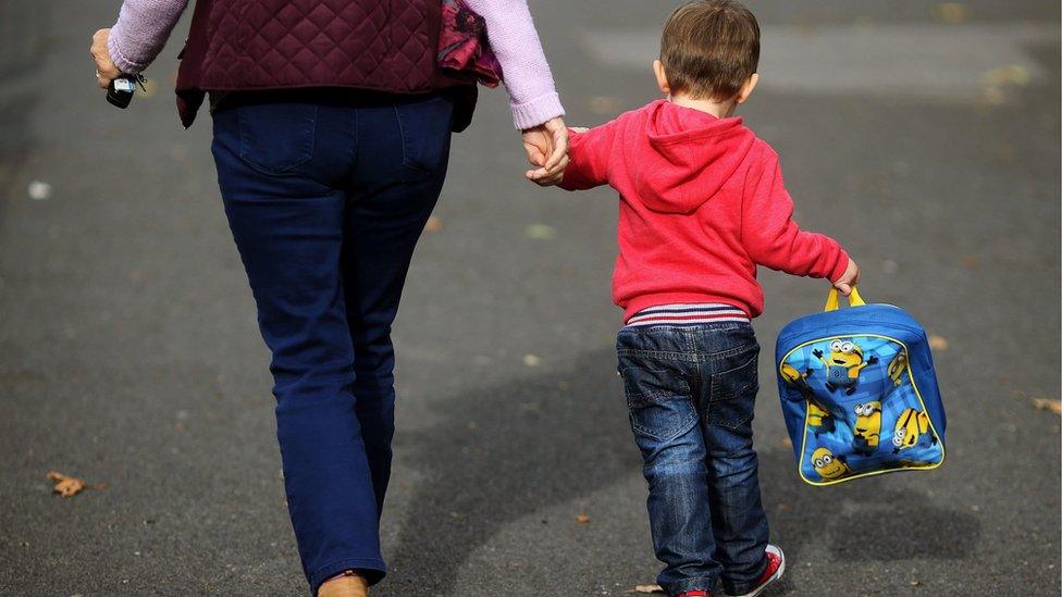 Woman and child walking to nursery