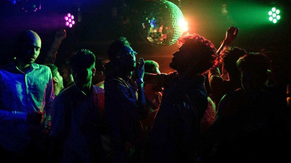 Men dancing in Kitty Su nightclub