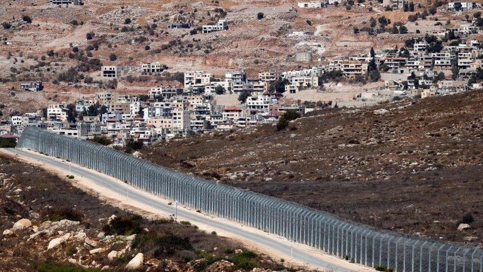 Israeli security fence separates the Israeli occupied sector of Golan Heights (right) from Syria