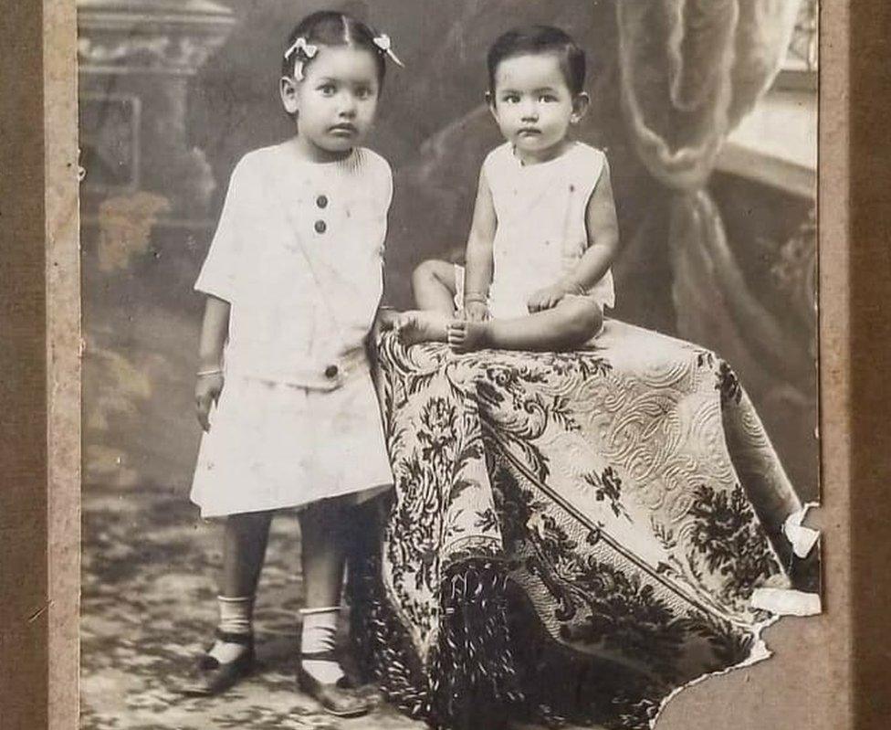 One-year-old Grace sits with her older sister Patsy