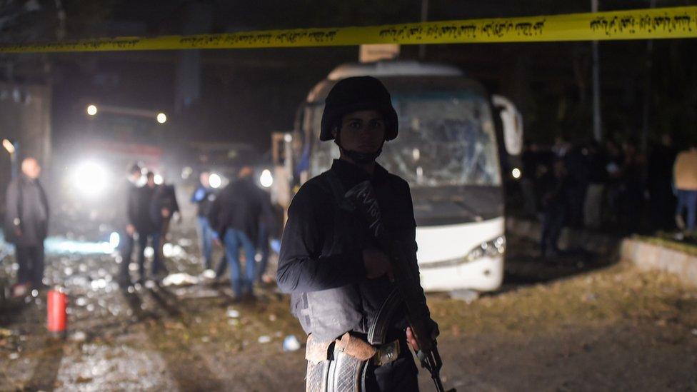 A policeman stands guard at the scene of the attack in Giza, 28 December