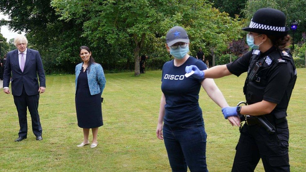 Prime minister and home secretary watch a search demonstration