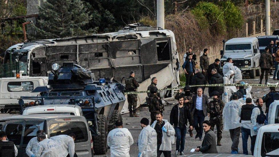 Turkish special force police officers walk at the site of a bomb attack in Diyarbakir, south-eastern Turkey, on March 31, 2016.