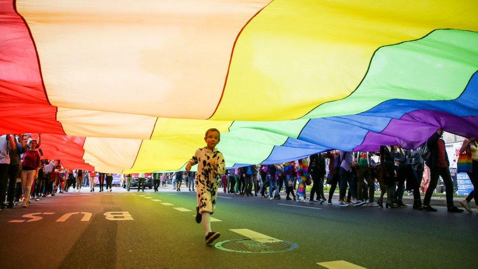 File photo of a child running underneath a rainbow