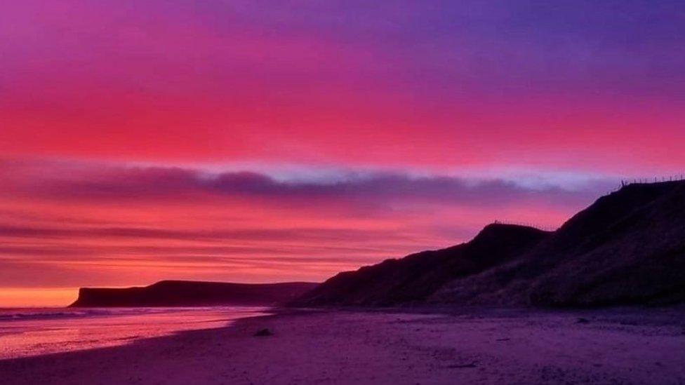 A red and purple sunset at the beach