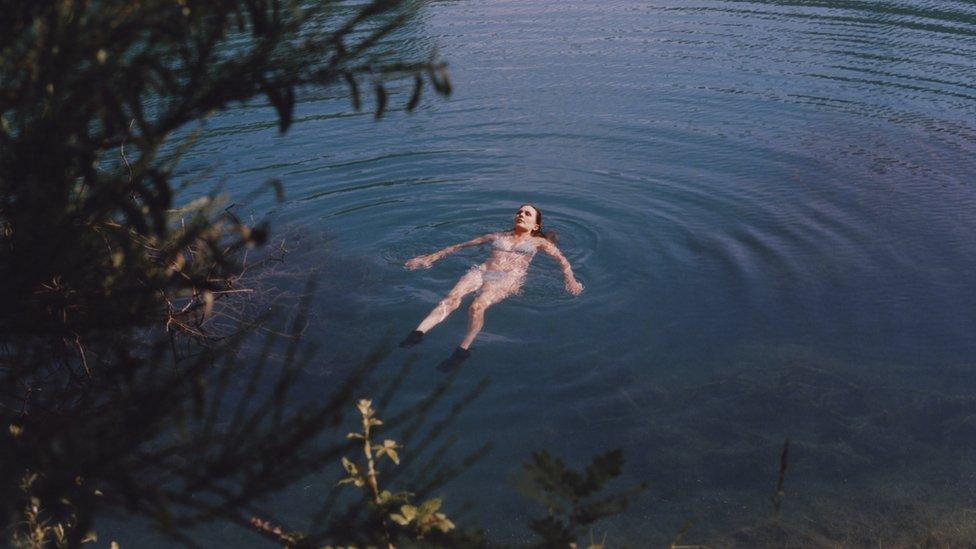 A swimmer cools off in one of the town's reservoirs