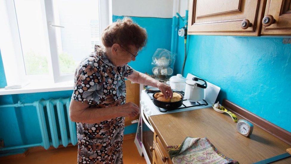 Elderly woman cooking