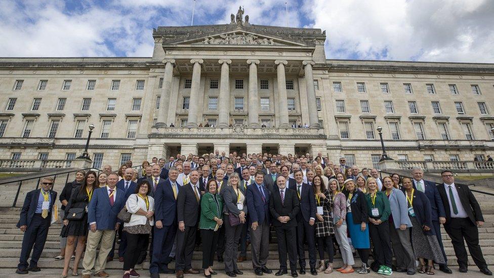 About 200 US politicians stand on the steps of Parliament Buildings at Stormont