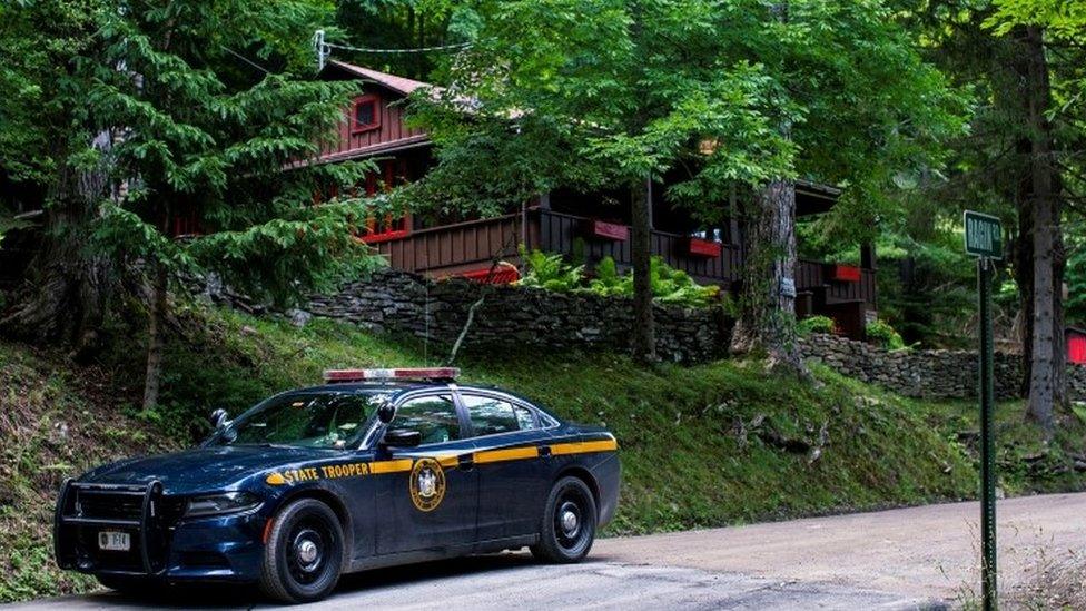 Police outside the home where the suspect was found dead