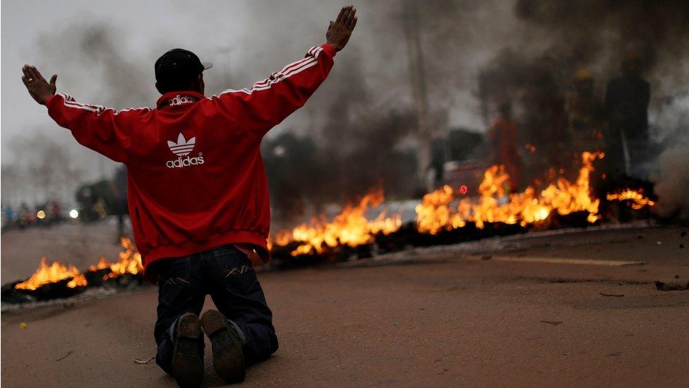 A protester guards a road block in Brasilia