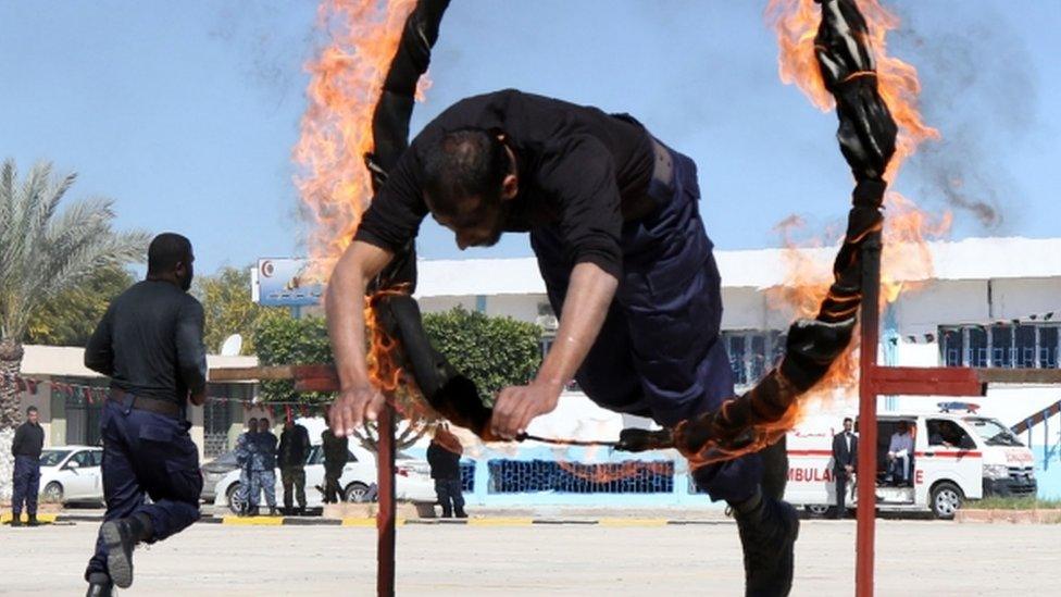 Members of the Libyan judicial police show their skills during a graduation ceremony on March 8, 2016 in the capital Tripoli.