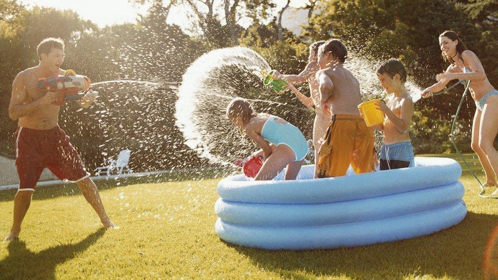 A family in a paddling pool