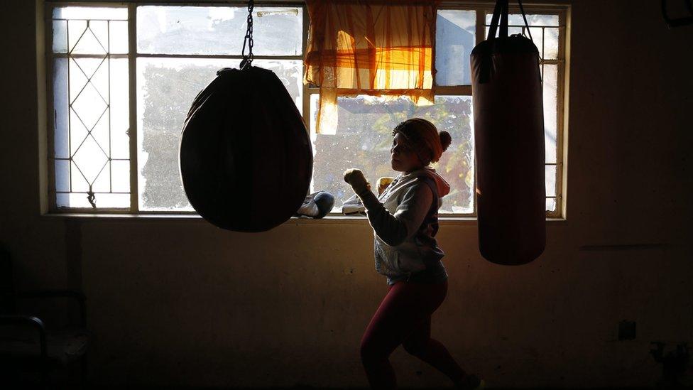 A female boxer trains during an early morning training session at the inner city boxing gym in Hillbrow, Johannesburg, South Africa, 06 June 2016. Boxers from the inner city boxing gym trained in memorial to the late Muhammad Ali, dubbed as "The Greatest," who died on 03 June 2016 in Phoenix, Arizona, USA, at the age of 74. A public funeral procession and memorial service will be conducted 10 June 2016 in Louisville. The Gym is situated in one of the country"s most dangerous inner city areas and is built in a dis-used petrol station. Both male and female boxers from all races train with George Khosi. Khosi was once The Soweto Super Middle weight boxing champion until one day in 1997 robbers shot him in both legs and in the right eye thus ending his boxing career. EPA/KIM LUDBROOK