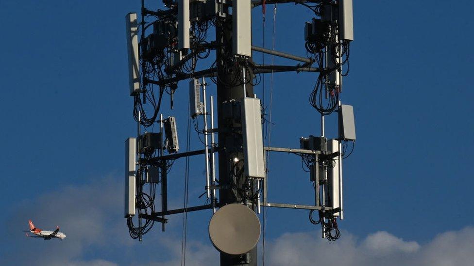 A set of antennas with a plane flying in the background, in South West Edmonton area. On Thursday, May 12, 2022, in Edmonton, Alberta, Canada.