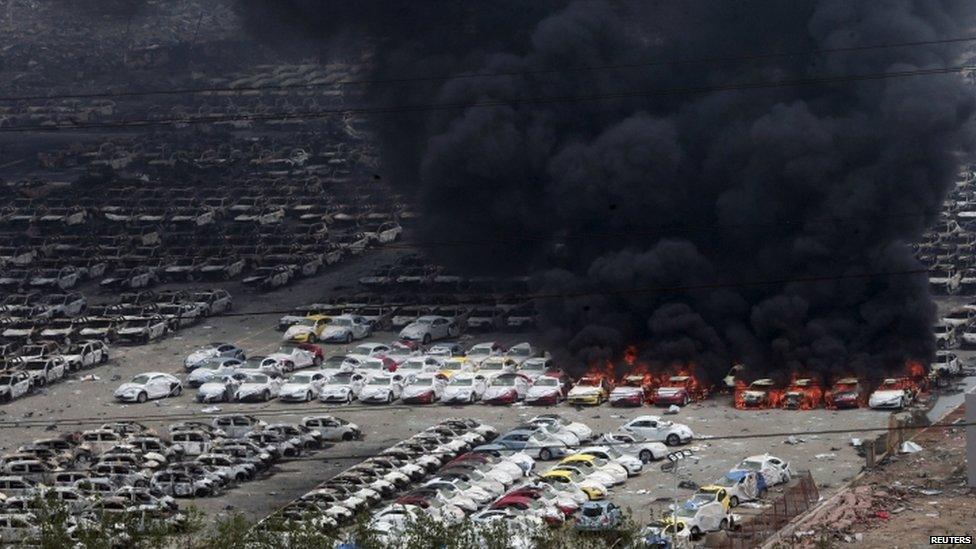 Damaged vehicles burning near blast site - 15 August