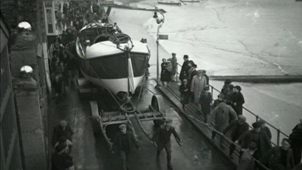 Lifeboat being pulled through streets