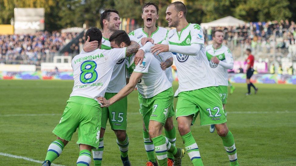 Wolfsburg players celebrate after scoring a goal in their match against SV Darmstadt 98 on October 24, 2015