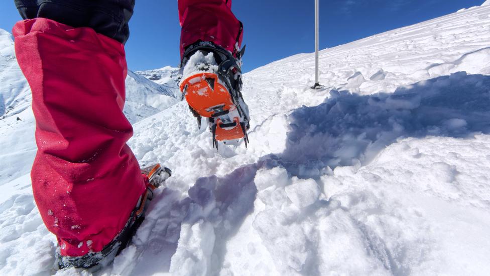 Climber's feet with crampons