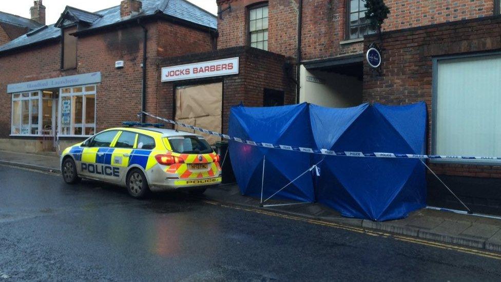 Police car outside the barbers' shop in Blandford Forum