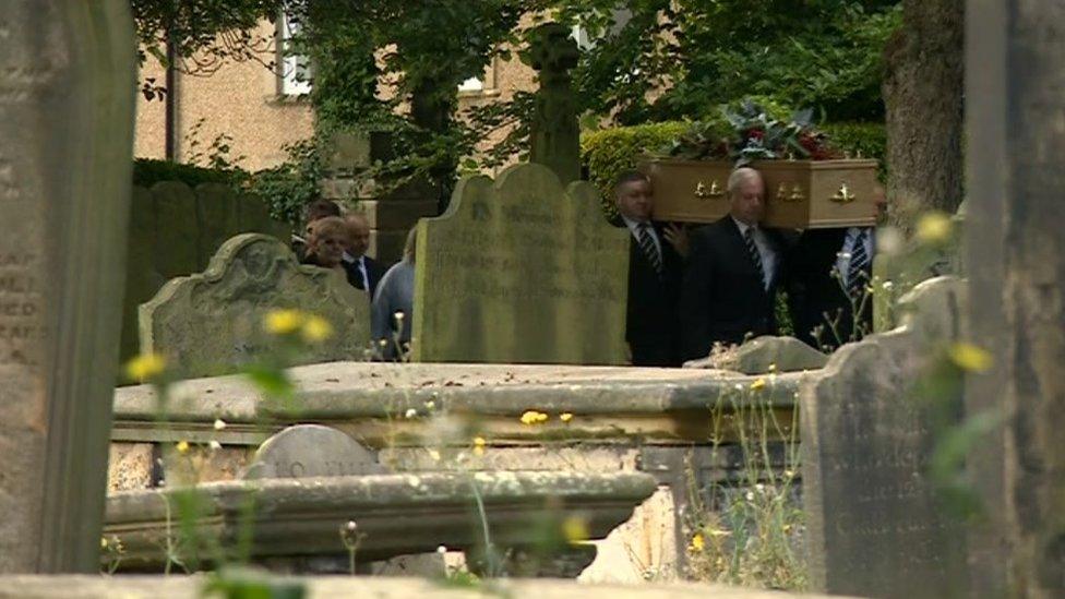 Mike Neville's coffin being taken towards the church