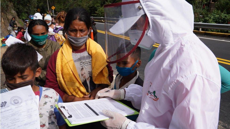 A worker for humanitarian group Consornoc registers migrants at the entrance to Pamplona, Colombia on Wednesday September 30.