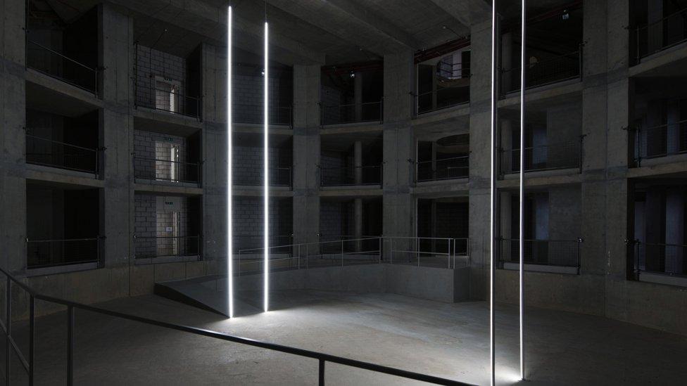 The bleak, bare, venue mimics an abandoned building site