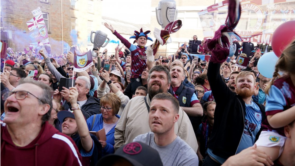 Fans ahead of the open-top bus parade