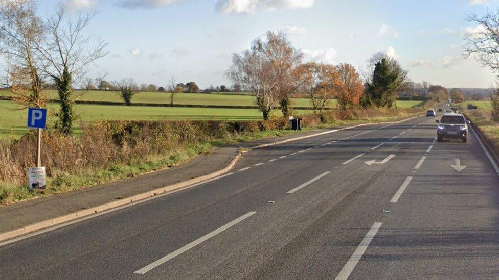 Main road with filter lane to small layby