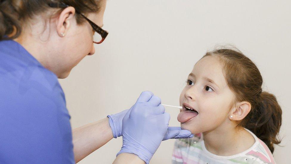 Nurse doing Covid test on child