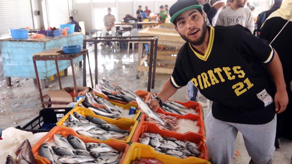 A man in a "Pirates 21" T-shirt at a fish market in Tripoli, Libya - Thursday 7 April 2016