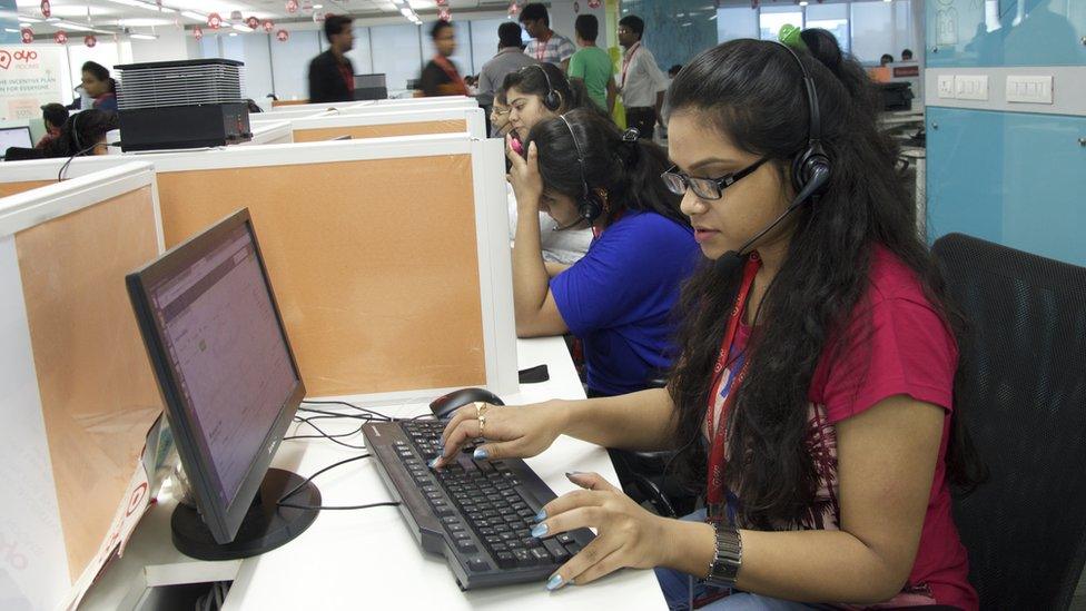 Young woman working at her desk at Oyo